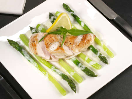 Filled Chicken with green Asparagus and Lemon Sauceの写真素材