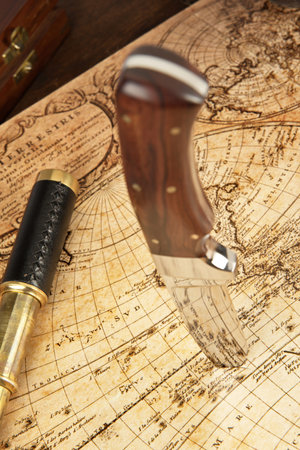 Knife sticking in an old map to locate the treasureの写真素材