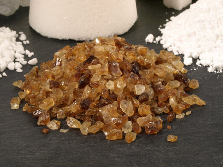 Brown Sugar and Various Sugars with Sugar Cone on black Backgroundの写真素材