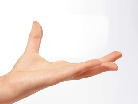 Children hand holding a white paper, isolated on white background.の写真素材