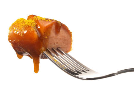 Curry Wurst on a Fork with Sauce - Isolatedの写真素材