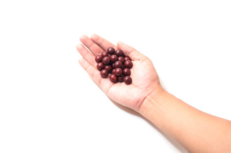 Chocolate ball on hand, isolated