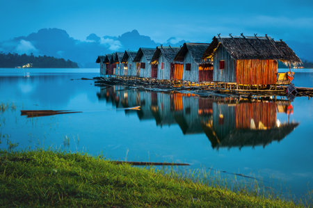 Landscape of floating accommodation the river with mountain background at midnight in Thailand