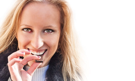 Girl eating chocolateの写真素材