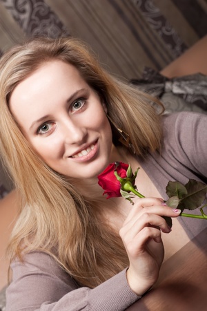 Smiling young girl with a flowerの写真素材