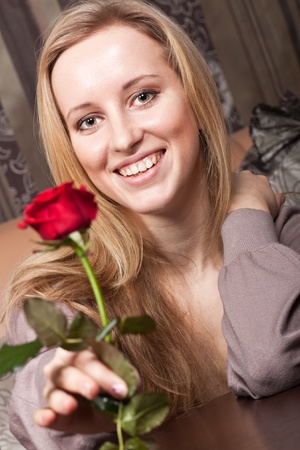 Cute smiling girl with a roseの写真素材
