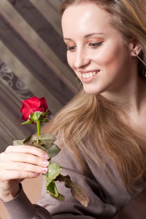 Pretty young woman with a red roseの写真素材