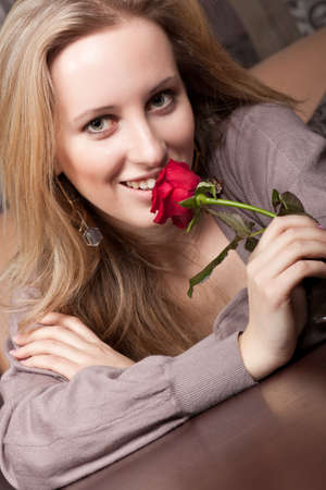 Beautiful young girl with a red roseの写真素材