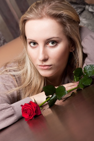 Sensual blonde girl with a red roseの写真素材
