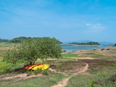 Bright color canoe park under shade from tree in Kaeng Krachan National Park, Phetchaburi, Thaiandの写真素材