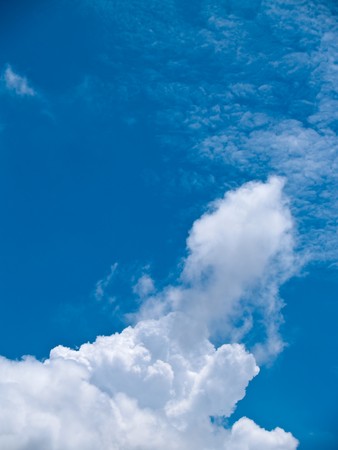 White fluffy clouds in the blue skyの写真素材
