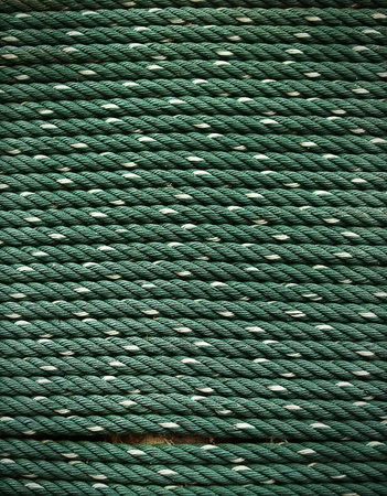 Bundle of old thick green nylon ropeの写真素材