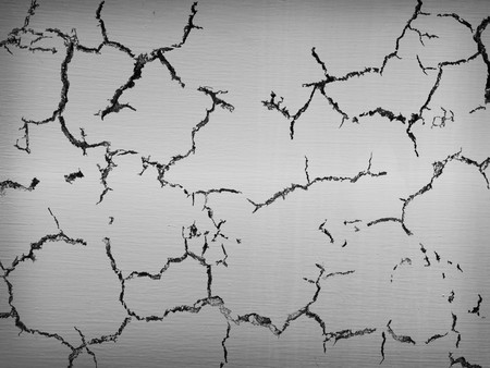 Closeup texture and detail of cracked silver metal plateの写真素材