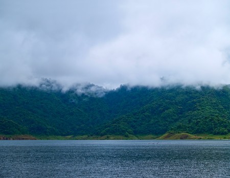 Misty mountain with forest and lake in morningの写真素材