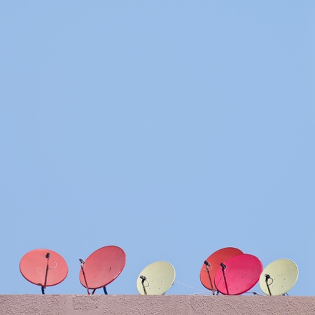 Colorful satellite dish on top of buildingの写真素材