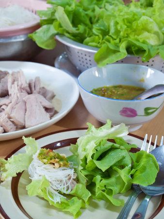 Thai style salad with leaf lettuce, noodle, slice boiling pork and spicy sauceの写真素材