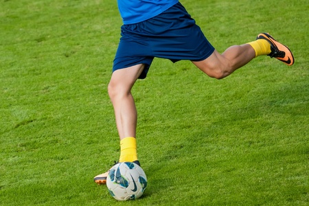 Soccer player kick the ball during matchの素材