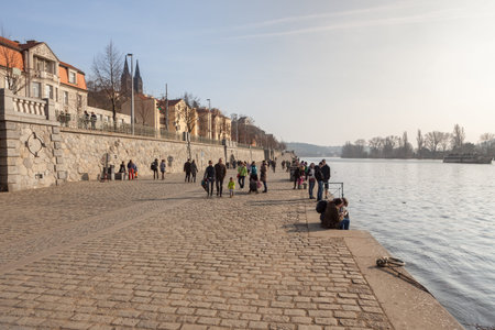 PRAGUE, CZECH REPUBLIC - MARCH 8th, 2014 - People walk on promenade of Vltava riverのeditorial素材