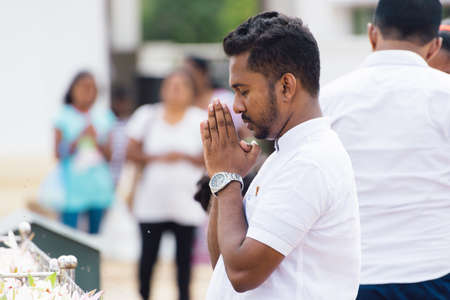 Anuradhapura, Sri Lanka - September 1, 2019: Young man praying pay respect to Buddhaのeditorial素材