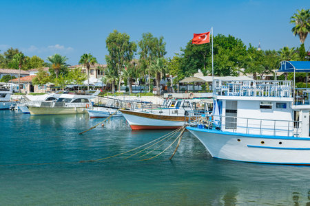 Beautiful harbor with boats in Side resort town at sunset - Antalya, Turkey.
