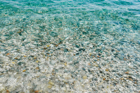 Pebble coast and waves in Antalia, Turkey. Konyaalti beach.