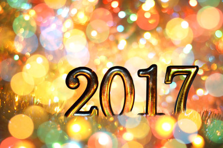 New year, Christmas background of colored holiday lights. Gold numbers in 2017.の写真素材