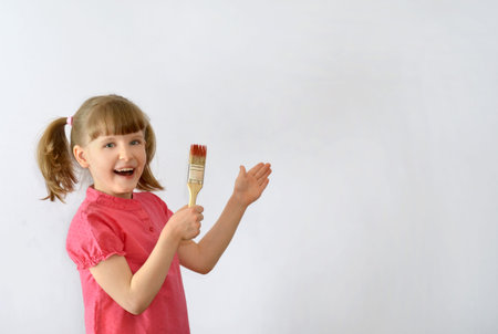 kid, child shows written on the poster with a brushの写真素材