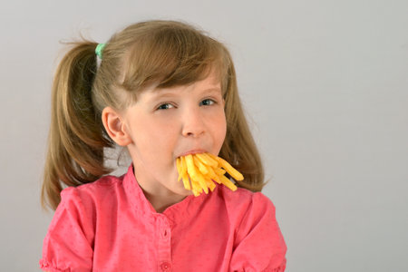 Child loves French fries. Fast food.の写真素材