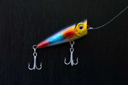 close up of colorful fishing lure on a black boardの写真素材