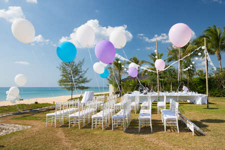 wedding setting on the beach with balloonsの写真素材