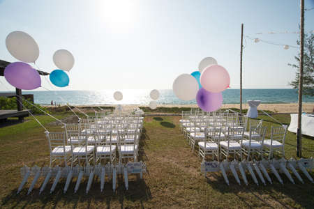 wedding setting on the beach with balloonsの写真素材