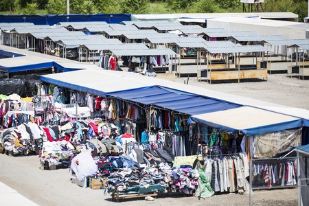 CHISINAU, MOLDOVA- Tourists and locals looking at the stalls at Chisinau flea market in Moldova. At the flea market one can find second hand clothes and shoes, souvenirs and paintingsの写真素材