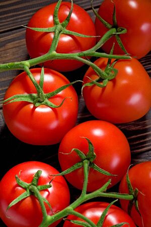 Fresh cherry tomatoes on rustic wooden background.の写真素材