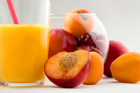 Glass of orange juice with fruit glass box isolated on white.の写真素材
