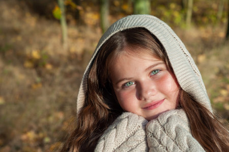 A young girl in a white hooded sweater.の写真素材