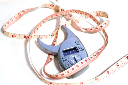 Measure the waist and  Fat monitor on white backgrounds isolateの写真素材