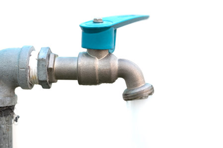 tap with flowing water against white background