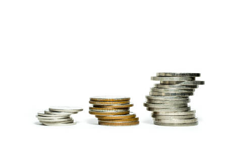 Three stacks of coin isolate on white backgroundの写真素材