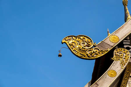 Detail on thailand temple roof against blue sky.の写真素材