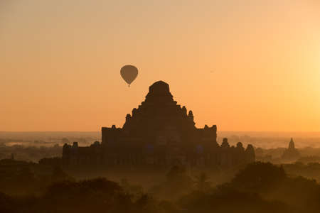Scenic sunrise with many hot air balloons above Bagan in Myanmarの写真素材