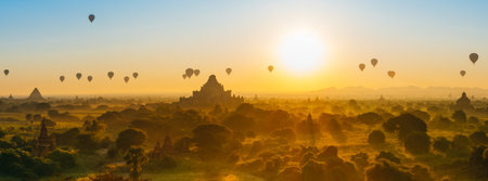Scenic sunrise with many hot air balloons above Bagan in Myanmar. Bagan is an ancient city with thousands of historic buddhist temples and stupas.の写真素材
