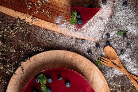 Fruit dairy multi-colored jelly on a plate. Fruit yogurt cake on wooden background. Cream and yogurt...