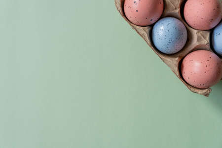 Easter eggs with space for text, top view of an open brown box of eggs, Easter green backgroundの写真素材