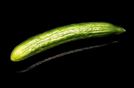 Cuecumber on reflecting black tableの写真素材