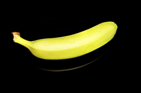 Banana on reflecting black tableの写真素材