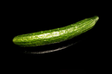 Cuecumber on reflecting black tableの写真素材