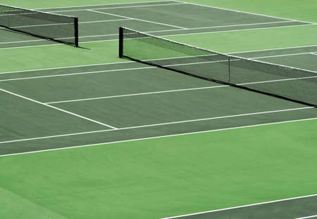 Aerial image of empty outdoor green hard tennis court with nets.の写真素材