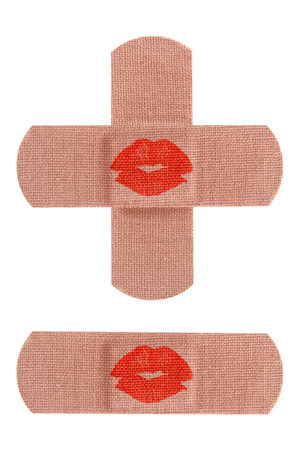 Set of adhesive medical bandages or bandaids with red kisses isolated on white background 