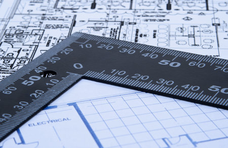 Set of architectural design blue prints with black angle ruler.
