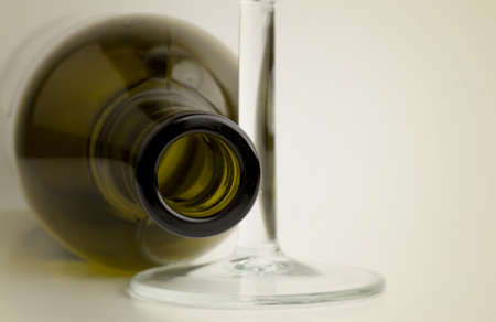 Empty green glass wine bottle with stem wineglass.の写真素材